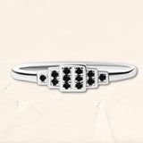 Brami geometric ring in white gold set with black diamonds