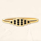 Brami geometric ring in yellow gold set with black diamonds