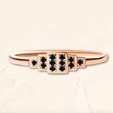 Brami geometric ring in rose gold set with black diamonds