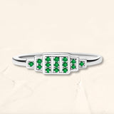 Brami ring in white gold set with emeralds