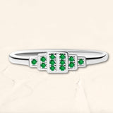 Brami ring in white gold set with emeralds