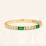 Semi eternity emerald and round diamond ring in 18 ct yellow gold