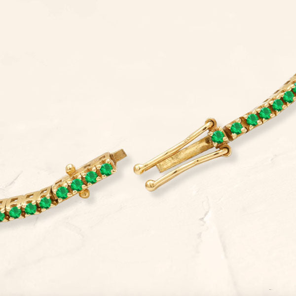 Tennis bracelet Ganga emerald in 18ct yellow gold with double safety catch