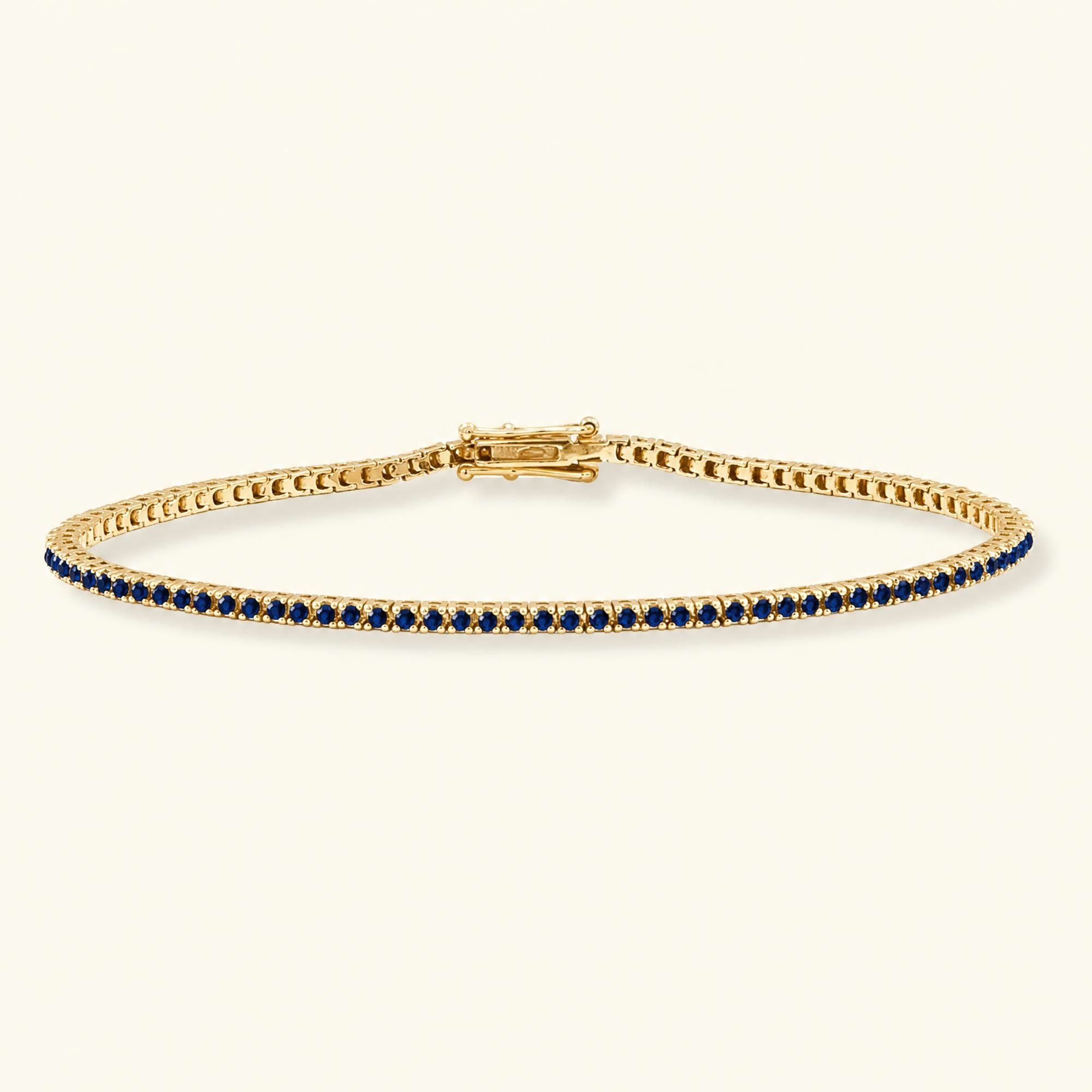 Bracelet tennis rivière en saphir et or jaune 18cts