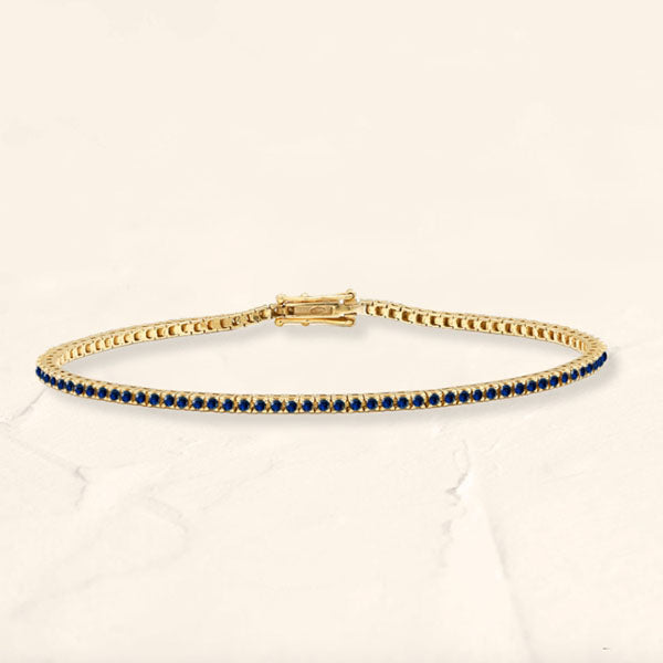 Bracelet tennis rivière en saphir et or jaune 18cts