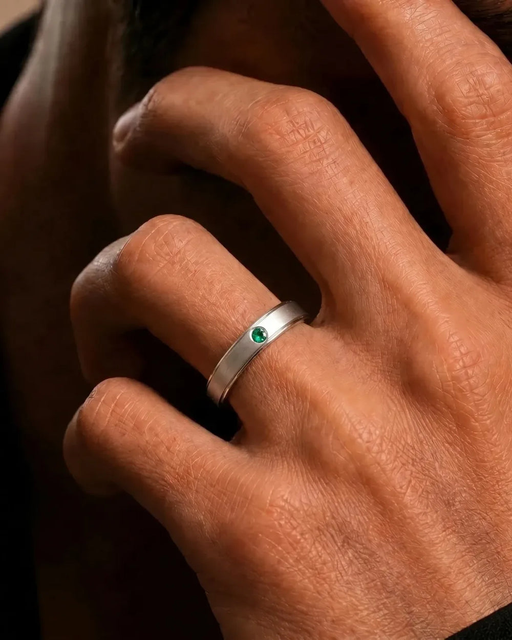 Jonc en or blanc 18 carats serti d'une émeraude porté au doigt par Mayuri