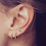 small earrings and emerald hoops