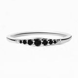 Sushma ring in white gold set with 7 black diamonds