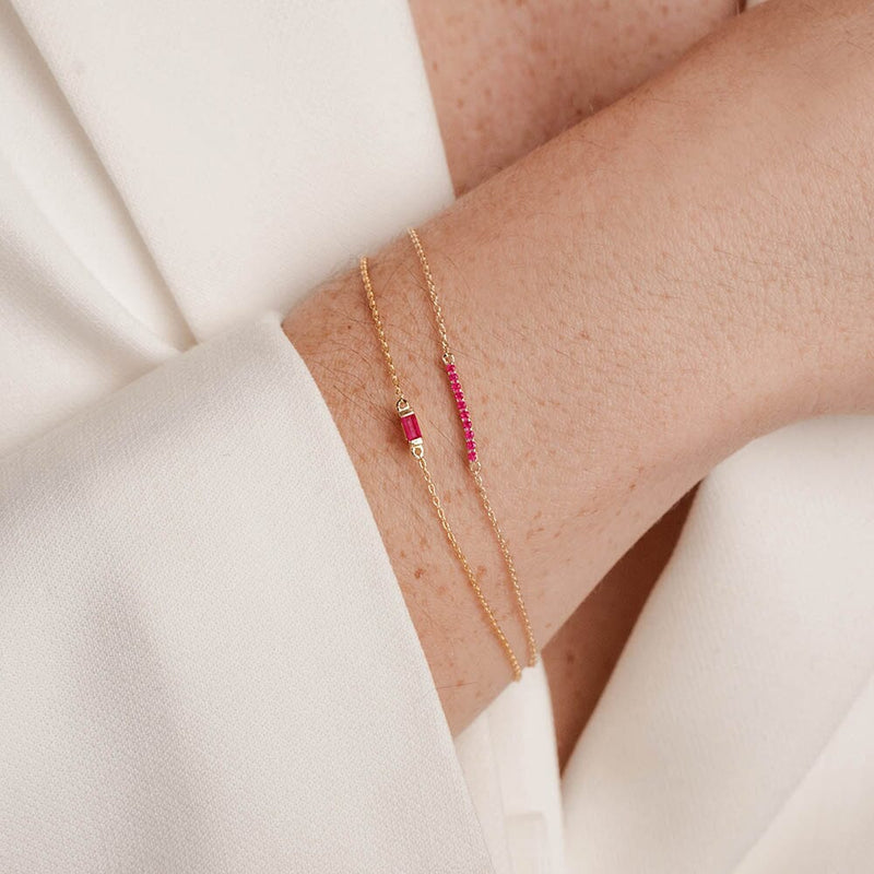 long ruby bar bracelet and ruby baguette with elegant outfit